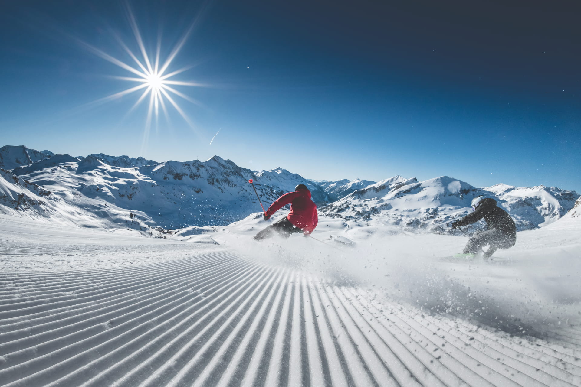 Zwei Skifahrer beim Skifahren auf den Pisten Obertauerns